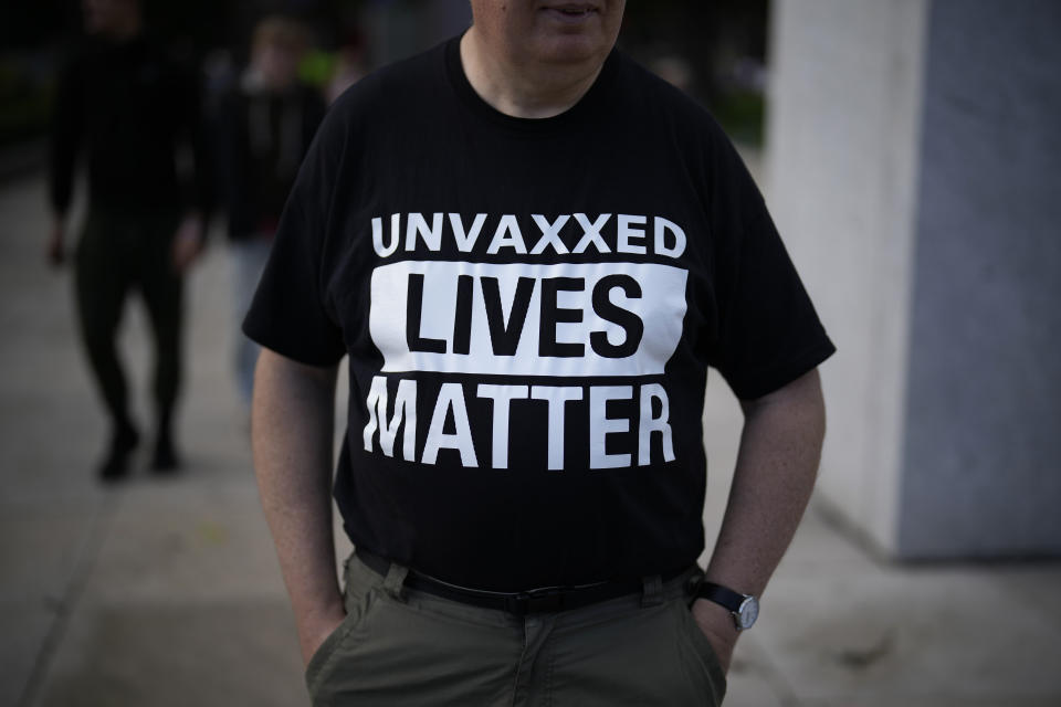 FILE - A protester wears a t-shirt against COVID-19 vaccinations, whilst standing on Parliament Square, opposite the Houses of Parliament, in London, Oct. 20, 2021. The pandemic is again roaring across parts of Western Europe, a prosperous region with relatively high vaccination rates and good health care systems but where lockdown measures to rein in the virus are largely a thing of the past. The U.K. had Europe’s highest infection rates for months after the government lifted remaining restrictions on social and economic life in mid-July — though cases have gone up and down since then, and now appear to be falling. (AP Photo/Matt Dunham, file)