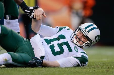 Dec 10, 2017; Denver, CO, USA; New York Jets quarterback Josh McCown (15) is helped up after a play in the third quarter against the Denver Broncos at Sports Authority Field at Mile High. Isaiah J. Downing-USA TODAY Sports