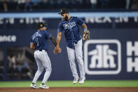 Tampa Bay Rays' Richie Palacios (1) and Amed Rosario, right, celebrate after they defeated the Toronto Blue Jays in a baseball game in Toronto, Friday, May 17, 2024. (Christopher Katsarov/The Canadian Press via AP)