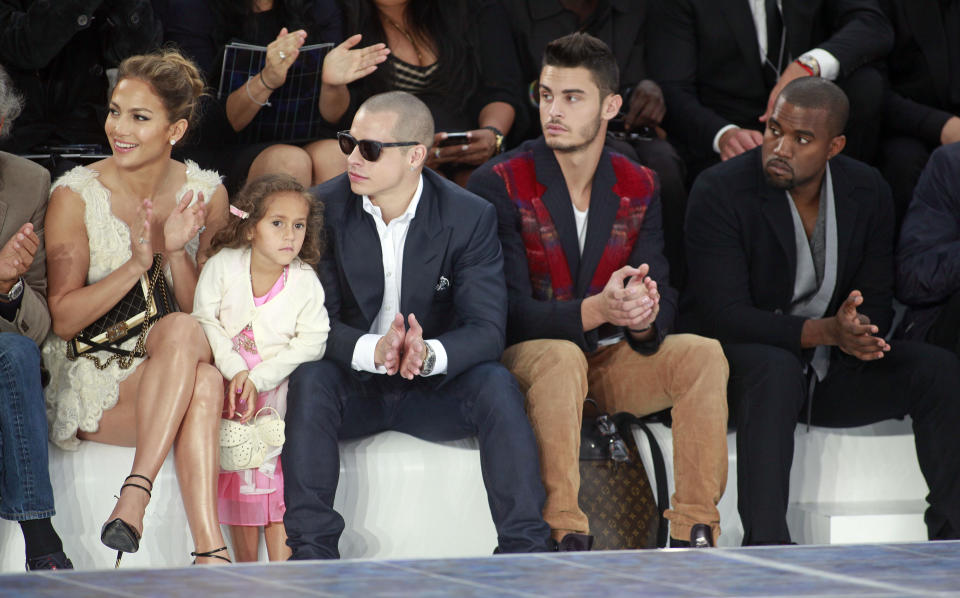 Jennifer Lopez, her boyfriend Casper Smart, her daughter Emme, model Baptiste Giabiconi, 2nd right, and Kanye West, right, watch Chanel's ready to wear Spring-Summer 2013 collection, presented in Paris, Tuesday, Oct.2, 2012. (AP Photo/Thibault Camus)