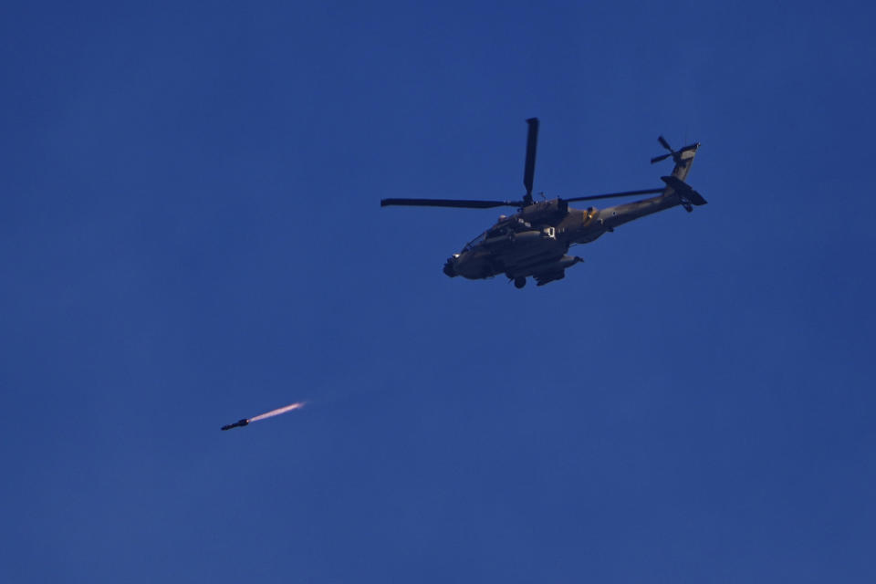 An Israeli Apache helicopter fires a missile in direction of the Gaza Strip, as seen from southern Israel, Wednesday, Dec. 6, 2023. (AP Photo/Ariel Schalit)