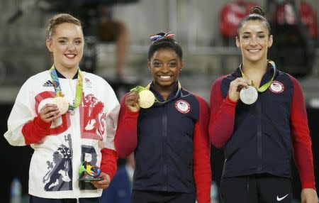 2016 Rio Olympics - Artistic Gymnastics - Final - Women's Floor Final - Rio Olympic Arena - Rio de Janeiro, Brazil - 16/08/2016. Gold medalist Simone Biles (USA) of USA, silver medalist Alexandra Raisman (USA) of USA (Aly Raisman) and bronze medalist Amy Tinkler (GBR) of Britain pose. REUTERS/Ruben Sprich