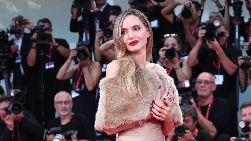 Angelina Jolie's faux fur shrug was a dead ringer for the kind worn by Marlene Dietrich and Joan Crawford in the 1930s. - Gisela Schober/Getty Images