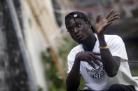 Joshua Samuel, who says he was shot during last year's police brutality protests, speaks with The Associated Press on Oct. 14, 2021, in Lagos, Nigeria. Samuel painfully recalls the day that Nigerian soldiers opened fire at the Lekki toll gate in Lagos while he and thousands of others were protesting brutal police practices. He is among more than 100 Nigerians awaiting a verdict from a panel that is reviewing both the Lekki shootings and allegations of police brutality that inspired the October 2020 protests. (AP Photo/Sunday Alamba)