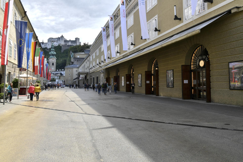 Out side view of the opera house , right, in Salzburg, Austria, Wednesday, Aug. 14, 2019 where singer Placido Domingo will perfom 'Luisa Miller' by Giuseppe Verdi. Numerous women have told The Associated Press that celebrated opera superstar Placido Domingo tried to pressure them into sexual relationships by dangling jobs and sometimes punishing them when they refused his advances. (AP Photo/Kerstin Joensson)