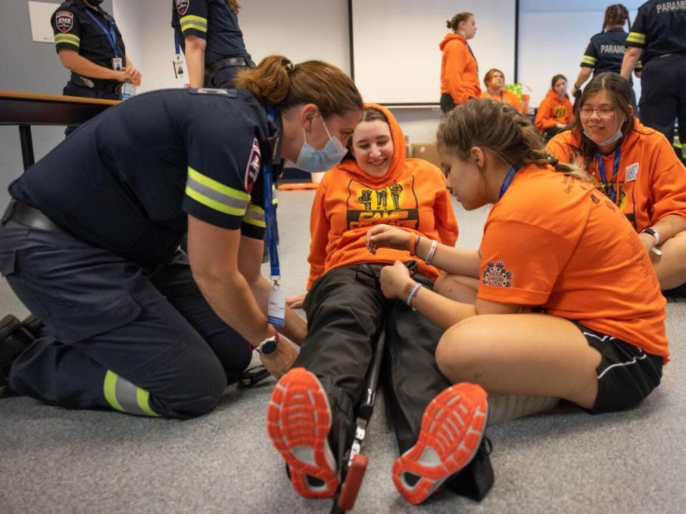 The girls at Camp Courage rotate stations, learning different skills like intubation, IV placement, and how to splint a broken leg. (Robert Short/CBC - image credit)