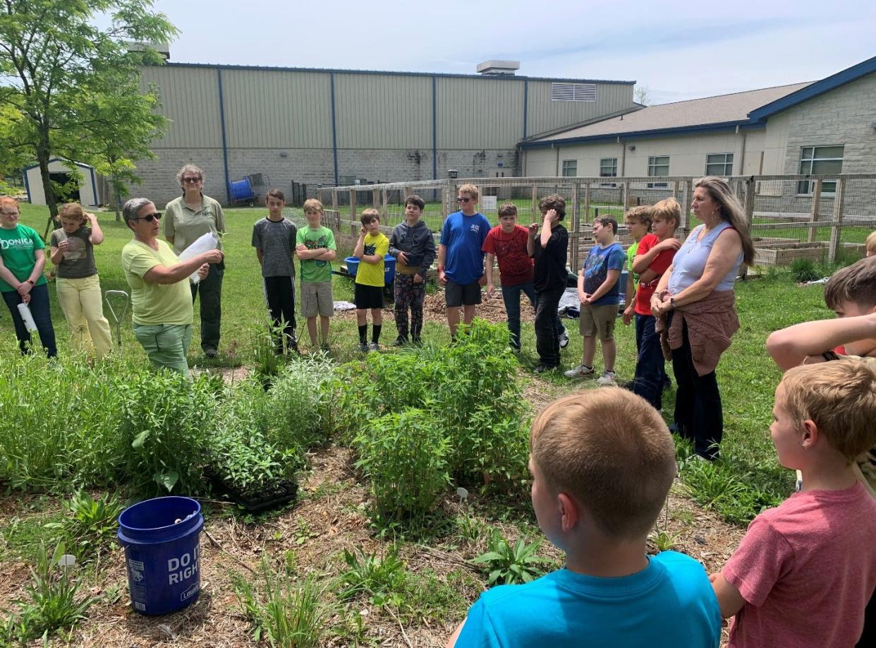 Hoosier National Forest staff assist Lawrence County Independent Schools students and teachers in planting more milkweed in their pollinator garden.