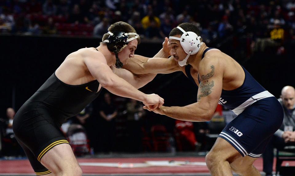 Penn State's Aaron Brooks, right, faces Iowa's Zach Glazier during the 197-pound final at the Big Ten Wrestling Championships. Brooks won by technical fall, 19-3.