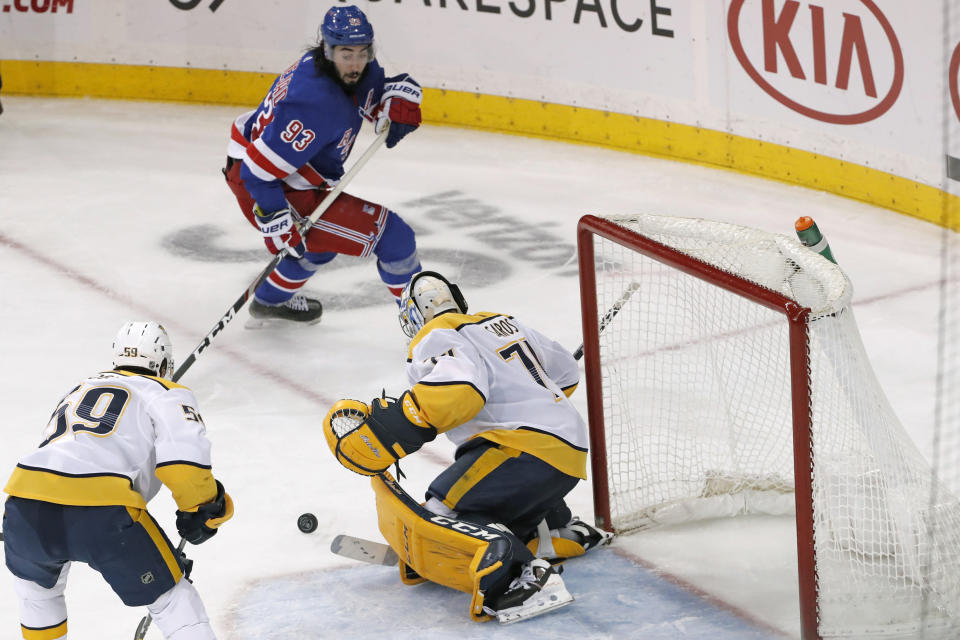 New York Rangers center Mika Zibanejad (93) and Nashville Predators defenseman Roman Josi (59) watch as Predators goaltender Juuse Saros (74) makes a save during the third period of an NHL hockey game, Monday, Dec. 16, 2019, in New York. The Predators defeated the Rangers 5-2. (AP Photo/Kathy Willens)