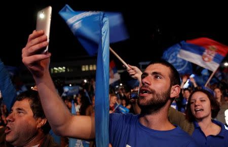 A supporter of opposition Democratic Front alliance takes a selfie during a pre-election rally in Podgorica, Montenegro, October 14, 2016. REUTERS/Stevo Vasiljevic