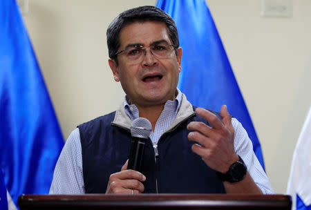 FILE PHOTO - Honduras President and National Party candidate Juan Orlando Hernandez gestures as he addresses the media at the Presidential House in Tegucigalpa, Honduras December 5, 2017. REUTERS/Jorge Cabrera