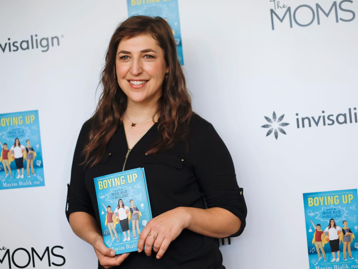 Mayim Bialik holds her book "Boying Up."