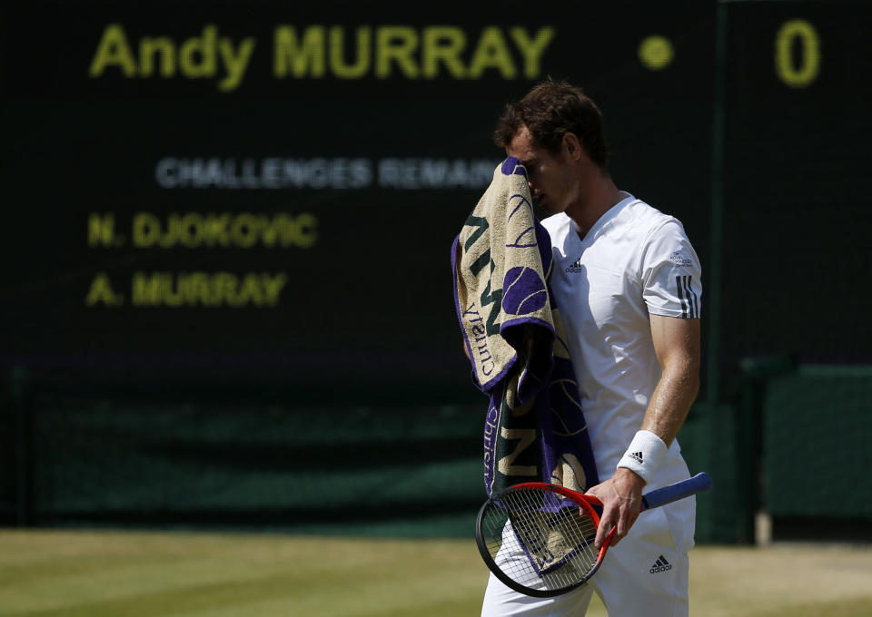 Great Britain's Andy Murray wipes his face in his Men's Final against Serbia's Novak Djokovic during day thirteen of the Wimbledon Championships at The All England Lawn Tennis and Croquet Club, Wimbledon.