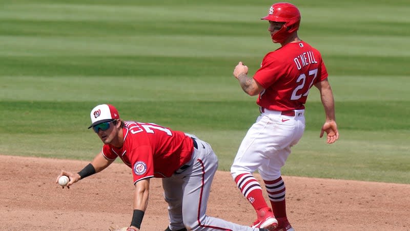 Washington Nationals second baseman Jackson Cluff, left, makes the play during the sixth inning of a spring training baseball game, Monday, March 15, 2021, in Jupiter, Fla.