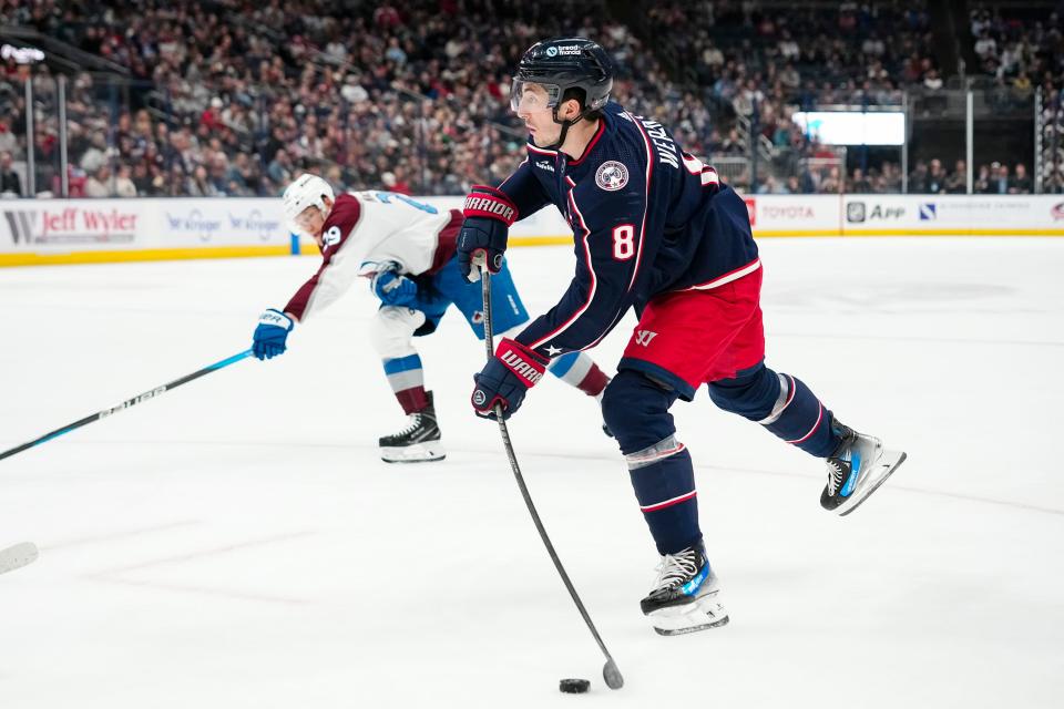 Apr 1, 2024; Columbus, Ohio, USA; Columbus Blue Jackets defenseman Zach Werenski (8) shoots past Colorado Avalanche center Nathan MacKinnon (29) during the first period of the NHL hockey game at Nationwide Arena.