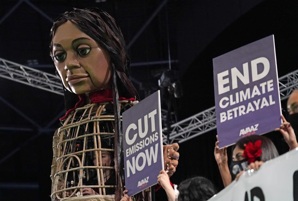 Giant puppet Little Amal walks through the Action Zone inside the venue of the COP26 U.N. Climate Summit in Glasgow, Scotland, Tuesday, Nov. 9, 2021. The U.N. climate summit in Glasgow has entered it's second week as leaders from around the world, are gathering in Scotland's biggest city, to lay out their vision for addressing the common challenge of global warming. (AP Photo/Alberto Pezzali)