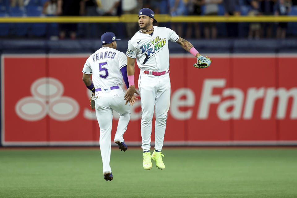 Tampa Bay Rays' Wander Franco (5) and Jose Siri, right, celebrate after a win over the Texas Rangers in a baseball game Friday, June 9, 2023, in St. Petersburg, Fla. (AP Photo/Mike Carlson)