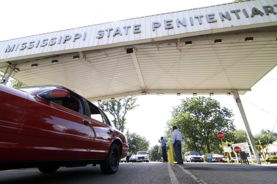 FILE - In this July 21, 2010, photograph, employees leave the front gate of the Mississippi State Penitentiary in Parchman, Miss. Another Mississippi inmate died at the hands of a fellow inmate, Thursday, Jan. 2, 2020, this time, at the penitentiary, bringing the death toll to four amid disturbances over the past week in the state prison system. The violence comes even as a federal judge, Tuesday, Dec. 31, 2019, rejected claims that conditions in one Mississippi prison are unconstitutionally harsh. (AP Photo/Rogelio V. Solis, File)