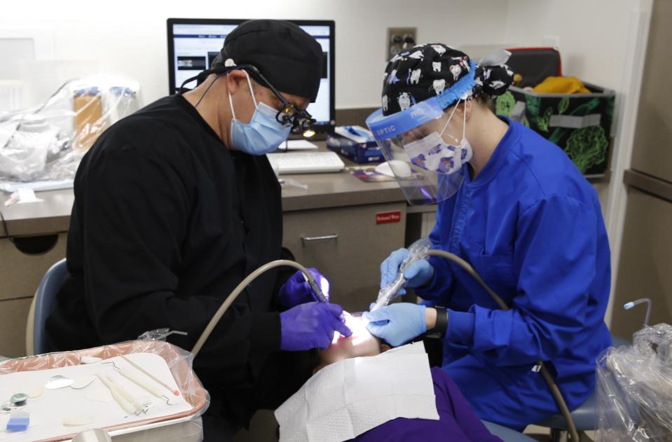 Dozens of dentists, dental hygienists and dental hygiene students combined their efforts to treat patients Friday, Feb. 2 during the 21st annual Give Kids a Smile Day free dental clinic at San Juan College.