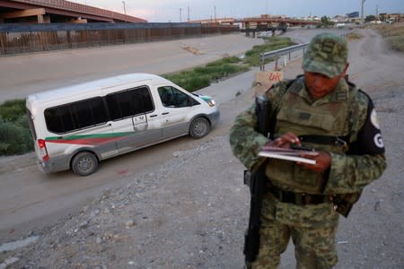 Soldiers assigned to the National Guard keep watch at the border between Mexico and the U.S. as part of an ongoing operation to prevent migrants from crossing illegally into the United States, in Ciudad Juarez