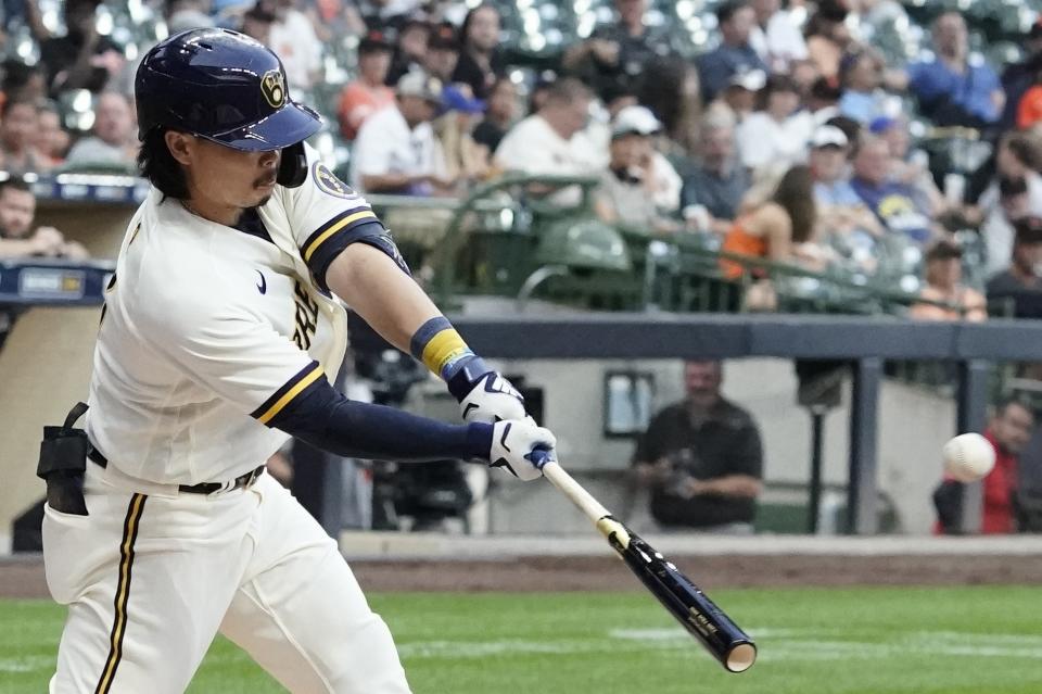 Milwaukee Brewers' Keston Hiura hits an RBI sacrifice fly during the first inning of game 2 of a doubleheader baseball game against the San Francisco Giants Thursday, Sept. 8, 2022, in Milwaukee. (AP Photo/Morry Gash)