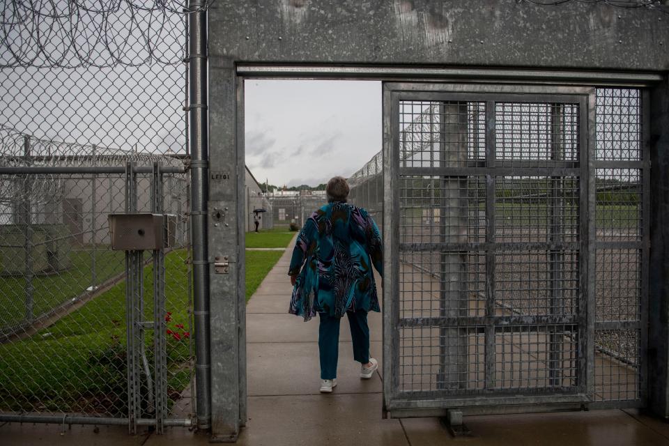 Willetta Grady walks through a gate at Trousdale Turner Correctional Facility, where she works as the librarian, in Hartsville, Tenn., on Monday, Aug. 14, 2023.