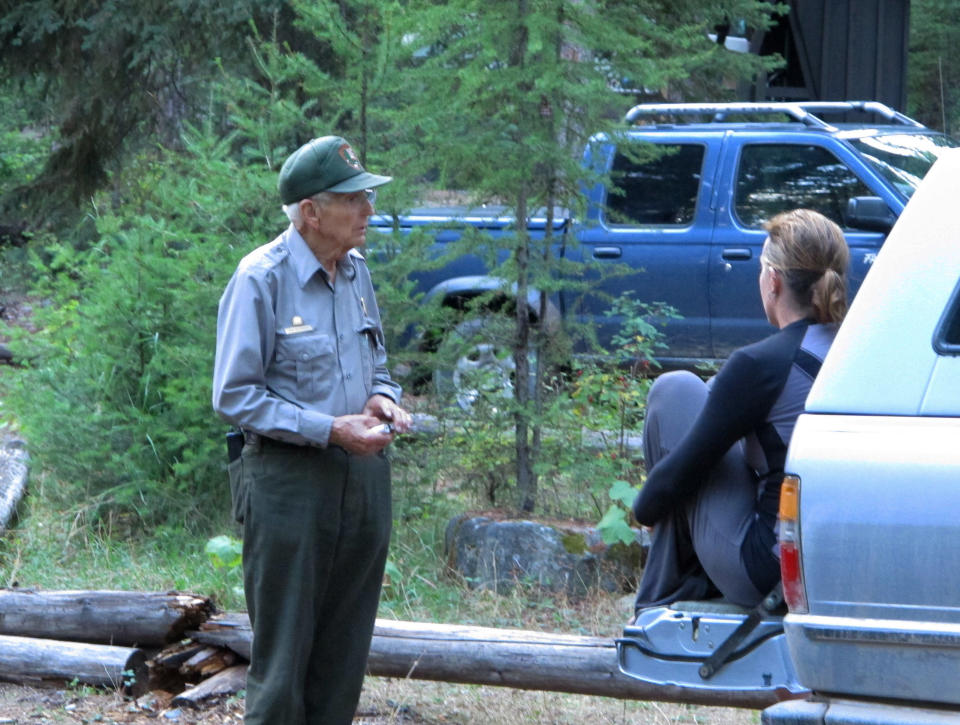 Lyle Ruterbories speaks with a visitor to the Kintla Lake Campground in Glacier National Park, Mont., on Thursday, Sept. 5, 2013. Ruterbories is the National Park Service's oldest ranger at age 93. Visitors who haven’t been to Kintla in a decade still greet him like a long-lost uncle. (AP Photo/Matt Volz)