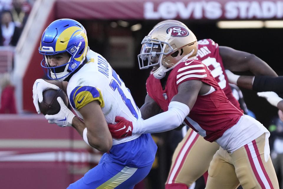 Los Angeles Rams wide receiver Puka Nacua, left, runs after catching a pass against the San Francisco 49ers in Santa Clara, Calif., Sunday, Jan. 7, 2024. Nacua set a rookie record for receiving yards on this play. | Loren Elliott, Associated Press