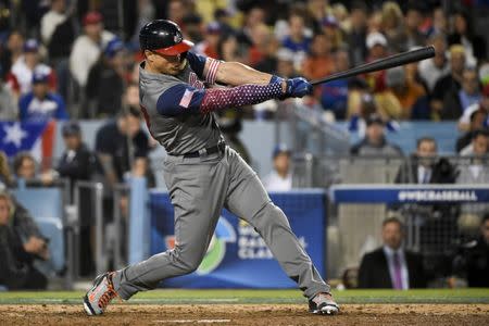 Mar 22, 2017; Los Angeles, CA, USA; United States designated hitter Giancarlo Stanton (27) hits an RBI single against Puerto Rico during the seventh inning of the 2017 World Baseball Classic at Dodger Stadium. Kelvin Kuo-USA TODAY Sports