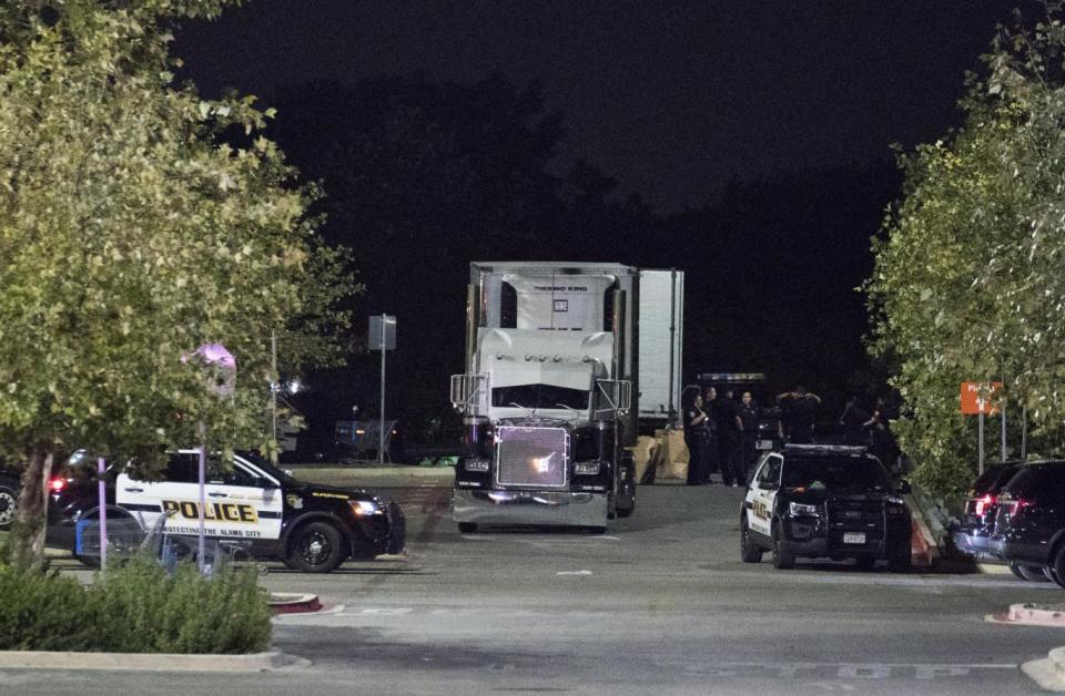 Officials investigate a truck that was found to contain 38 suspected illegal immigrants and eight dead bodies in San Antonio (EPA)