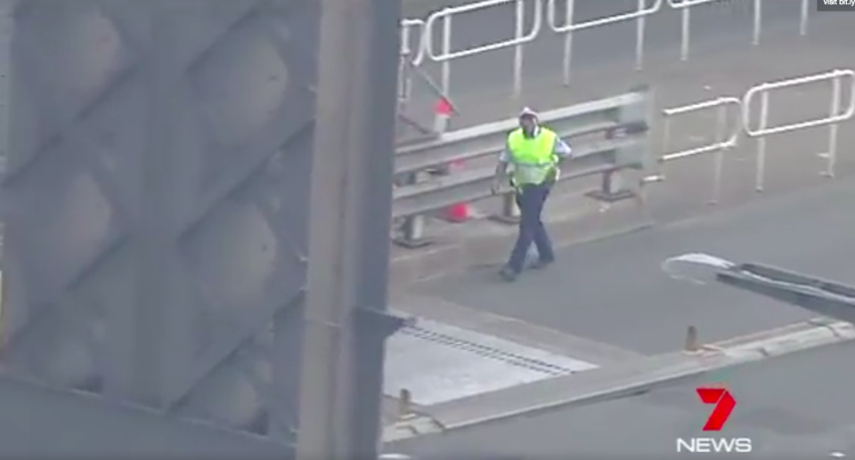 A police officer on the Sydney Harbour Bridge, during a police operation. Photo: 7 News