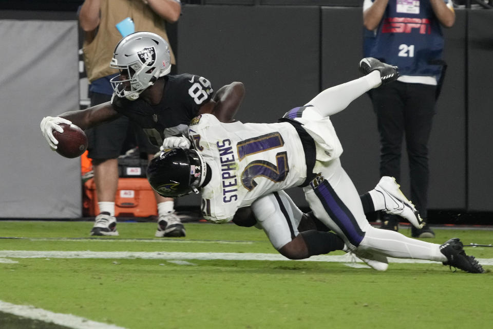 Las Vegas Raiders wide receiver Bryan Edwards (89) dives for yardage against Baltimore Ravens cornerback Brandon Stephens (21) during overtime in an NFL football game, Monday, Sept. 13, 2021, in Las Vegas. (AP Photo/Rick Scuteri)