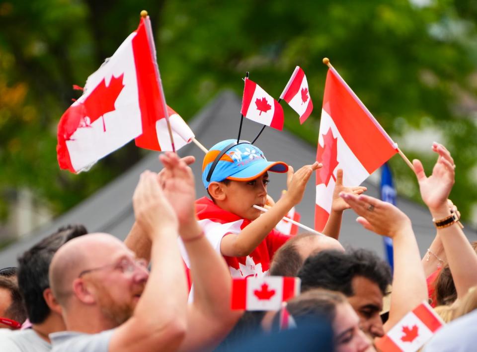 People clap during Canada Day celebrations at LeBreton Flats in Ottawa July 1, 2022.