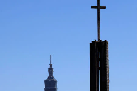 A Catholic church is seen in front of Taiwan's landmark Taipei 101 building in Taipei March 11, 2018. REUTERS/Tyrone Siu