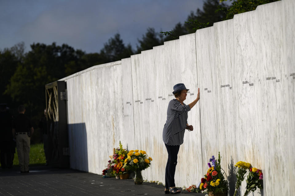 A relative of one of the victims pays her respects at the Wall of Names before a ceremony commemorating 22 years since the crash of Flight 93 during the 9/11 terrorist attacks, at the Flight 93 National Memorial, on Sept. 11, 2023 in Shanksville, Pennsylvania.  / Credit: Jeff Swensen/Getty Images