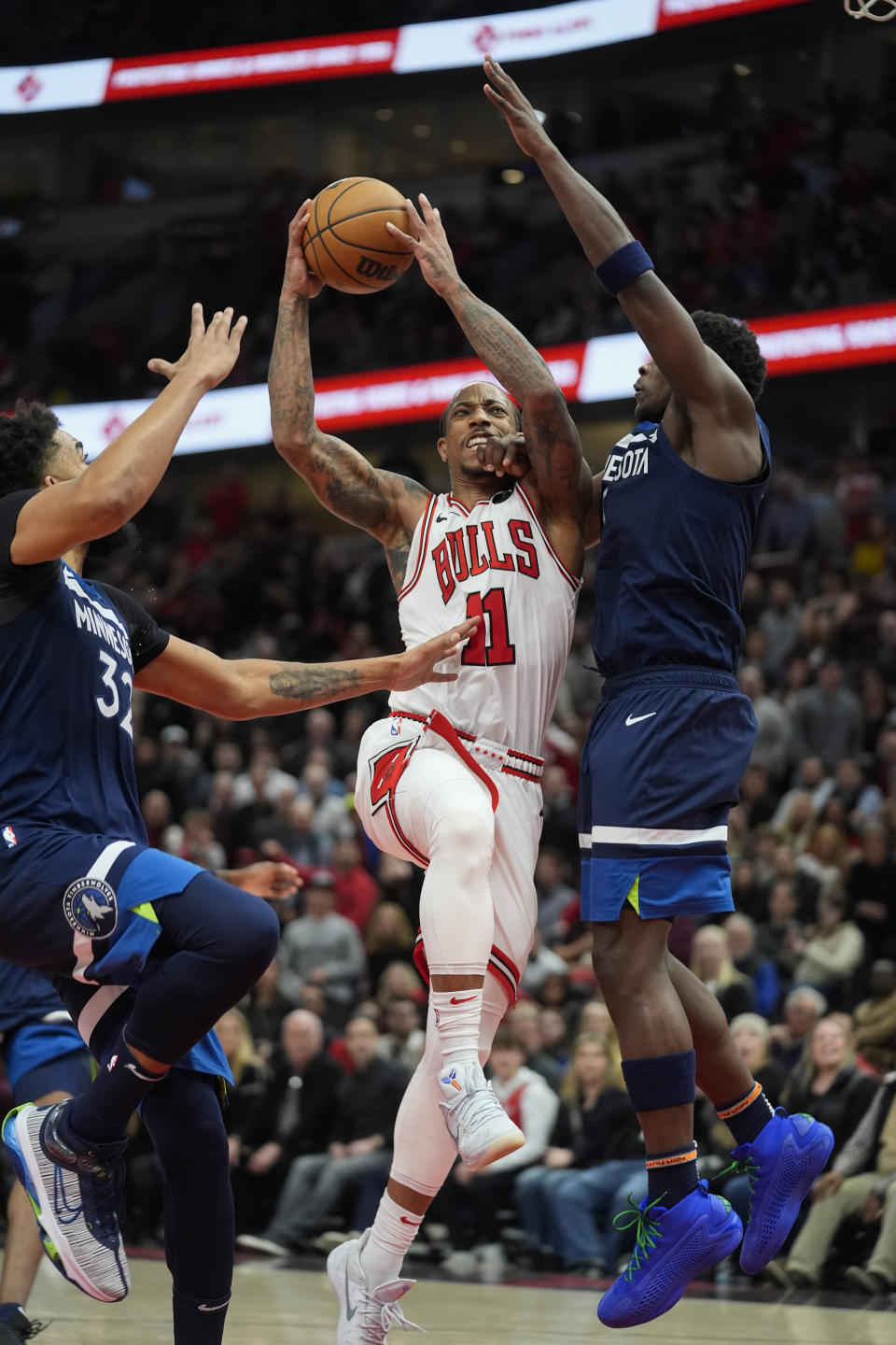 Chicago Bulls forward DeMar DeRozan is fouled by Minnesota Timberwolves guard Anthony Edwards, right, during overtime in an NBA basketball game Tuesday, Feb. 6, 2024, in Chicago. (AP Photo/Erin Hooley)