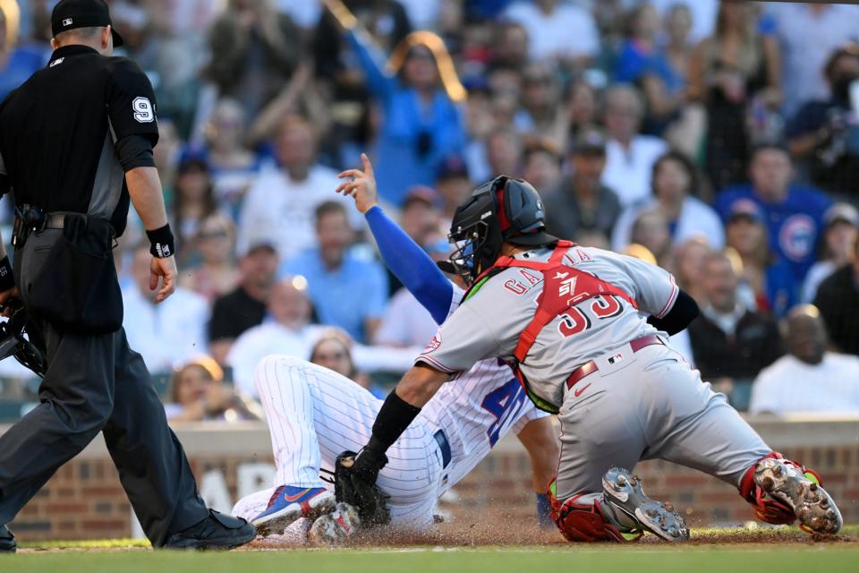 Chicago Cubs' Willson Contreras (40) scores as Cincinnati Reds catcher Aramis Garcia (33) applies a late tag during the first inning of a baseball game Wednesday, June 29, 2022, in Chicago.