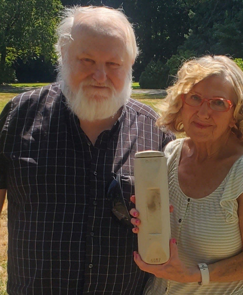 Eddy Hardy and Sandi Durham with their grandmother's cremated ashes from the Oregon State Hospital on July 6 at Belcrest Memorial Park in Salem.