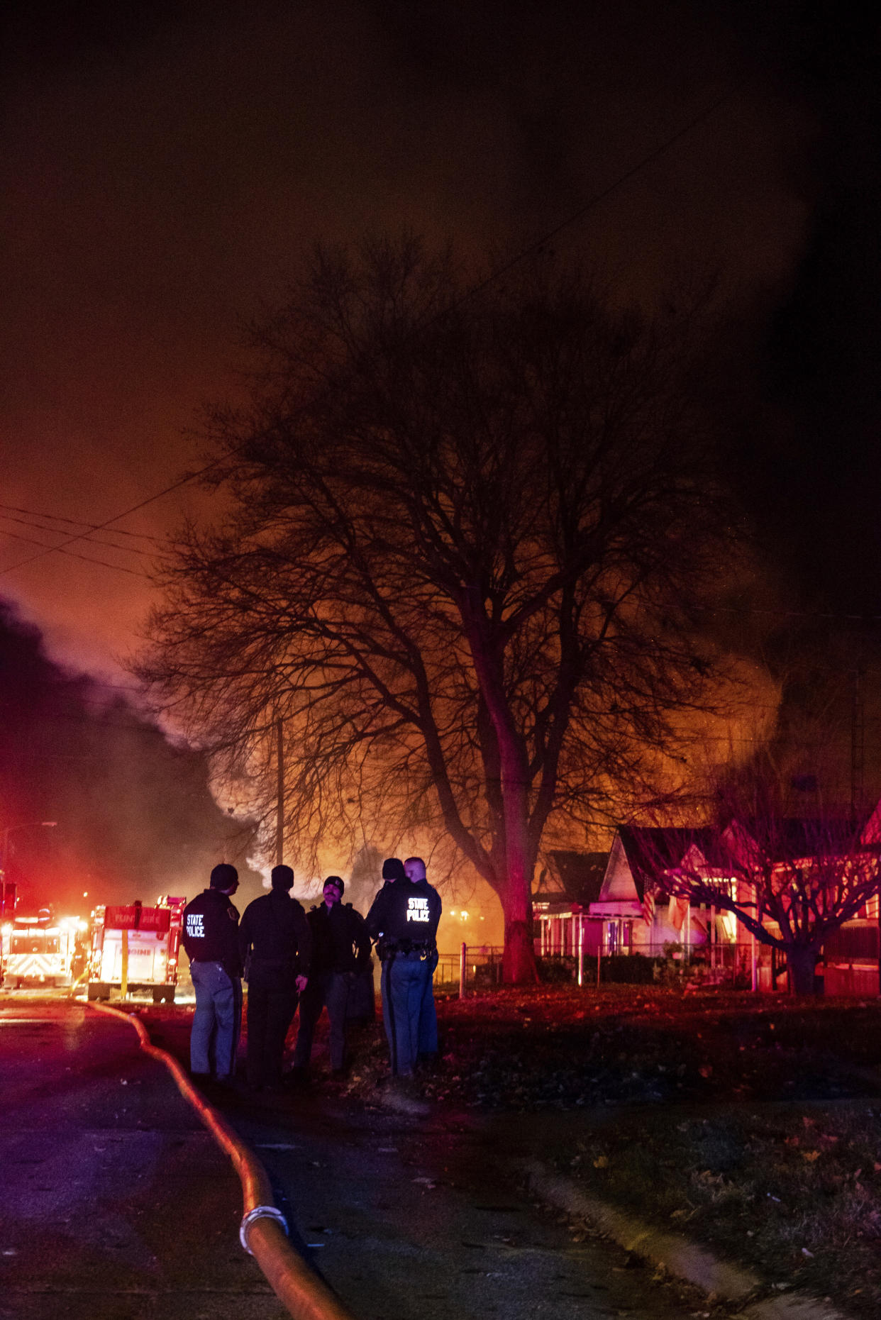 Emergency personnel are shown at the scene of a fire and explosion at a home in Flint, Mich., Monday night, Nov. 22, 2021. Three people were missing following the fire and explosion, authorities said. (Isaac RitcheyThe Flint Journal via AP)