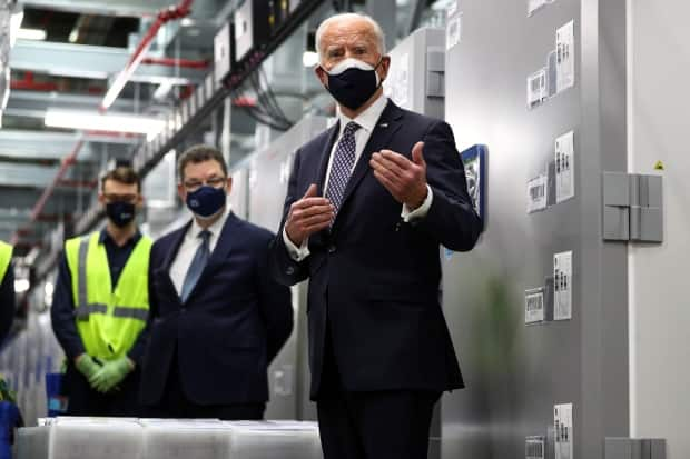 A U.S. lawmaker has said vaccinating Canadians and Mexicans against COVID-19 needs to be a future priority. In this photo, U.S. President Joe Biden tours a Pfizer manufacturing plant producing the vaccine in Kalamazoo, Mich., last month.  (Tom Brenner /Reuters - image credit)