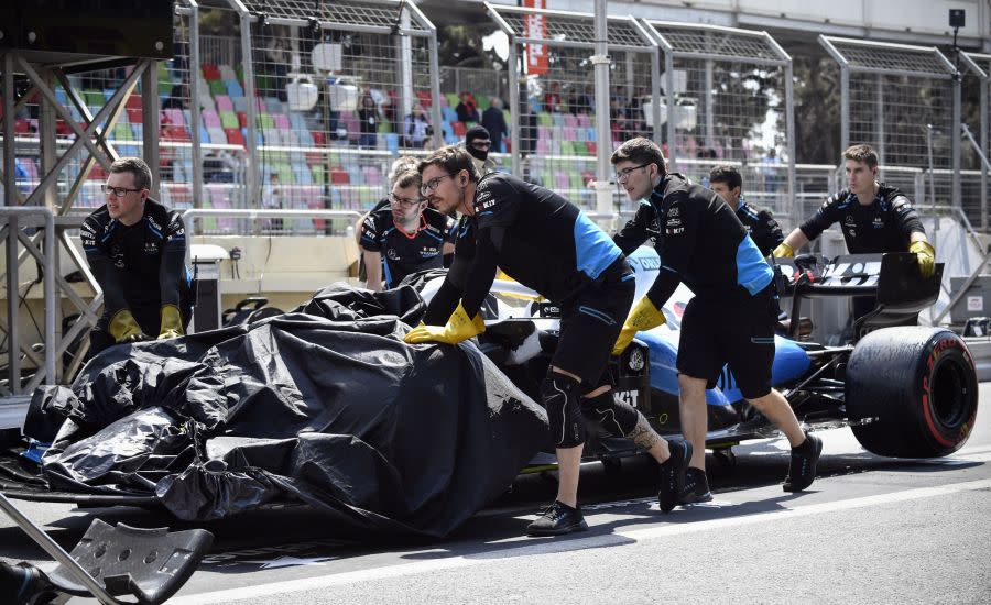 Technicians remove the damaged car of Williams’ British driver George Russell during the first practice session ahead of the Formula One Azerbaijan Grand Prix in Baku on April 26, 2019. – George Russell running over a loose drain cover limited running in Free Practice 1 for the Azerbaijan Grand Prix to just 12 minutes as track repairs were effected. (Photo by Alexander NEMENOV / AFP) (Photo credit should read ALEXANDER NEMENOV/AFP via Getty Images)