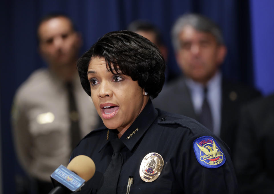 FILE - In this May 8, 2017 file photo Phoenix Police Chief Jeri L. Williams makes an announcement during a news conference in Phoenix. Police departments in at least five states are investigating, and in some cases condemning, their officers’ social media feeds after the weekend publication of a database that appears to catalog thousands of bigoted or violent posts by active-duty and former cops. Williams has moved some officers to “non-enforcement” assignments while the department probes Facebook posts she called “embarrassing and disturbing.” The database included nearly 180 posts tied to current Phoenix police officers that disparage Muslims, black people, transgender people and other groups. (AP Photo/Matt York, file)