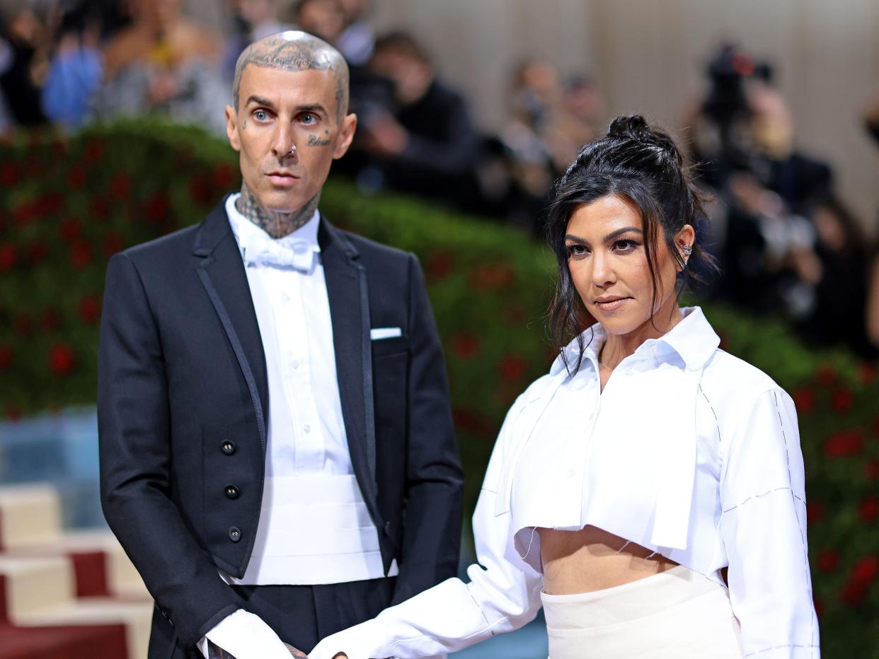 Kourtney Kardashian and Travis Barker attend the 2022 Met Gala.