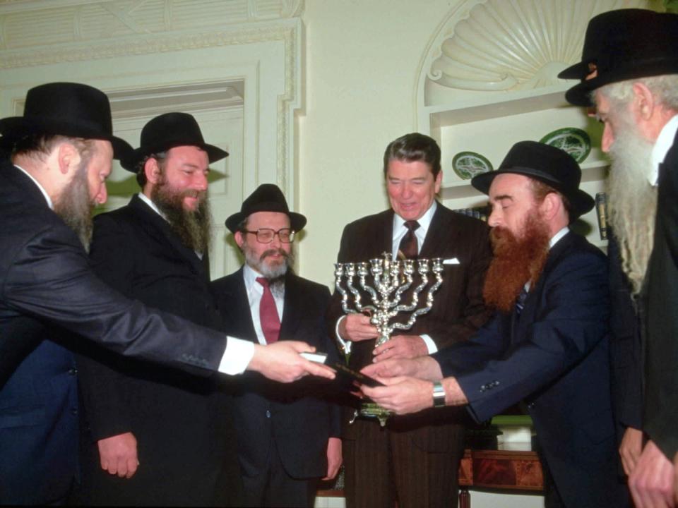 Ronald Reagan greets rabbis and receives a menorah at the White House on Hanukkah in 1984.