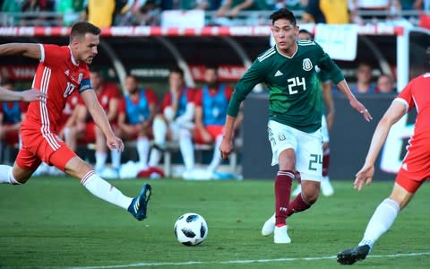 Edson Alvarez of Mexico (centre R) passes the ball while under pressure from Aaron Ramsey of Wales (L)  - Credit: AFP