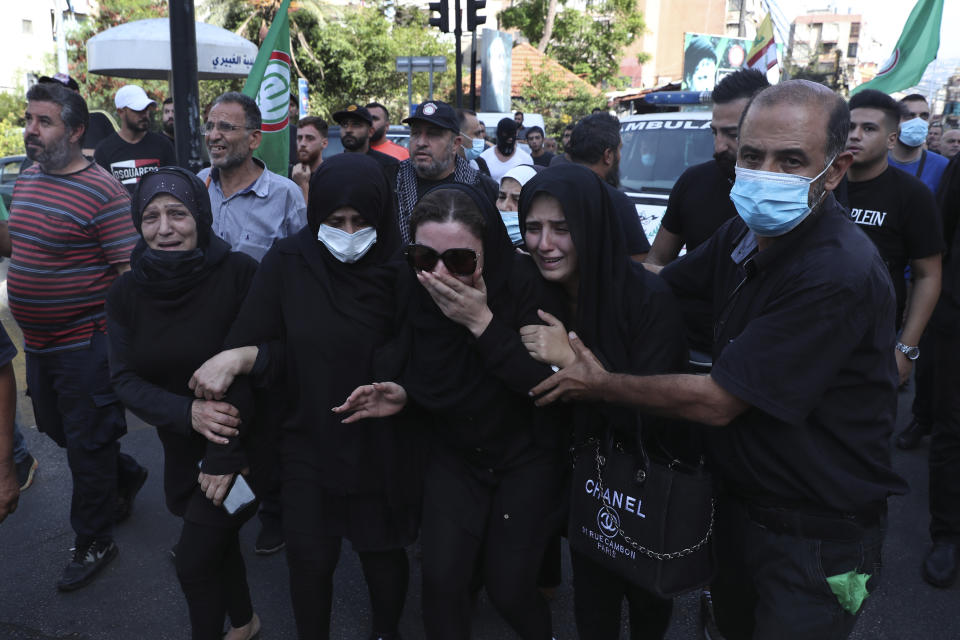 Family of Hassan Jamil Nehmeh mourn during his funeral processions in the southern Beirut suburb of Dahiyeh, Lebanon, Friday, Oct. 15, 2021. The government called for a day of mourning following the armed clashes, in which gunmen used automatic weapons and rocket-propelled grenades on the streets of the capital, echoing the nation’s darkest era of the 1975-90 civil war. (AP Photo/Bilal Hussein)