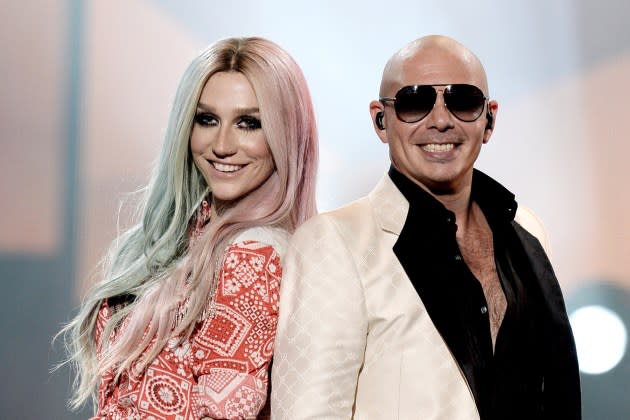 Singers Ke$ha, (L) and Pitbull perform onstage during the 2013 American Music Awards at Nokia Theatre L.A. Live on November 24, 2013 in Los Angeles, California.  - Credit: Kevin Winter/Getty Images