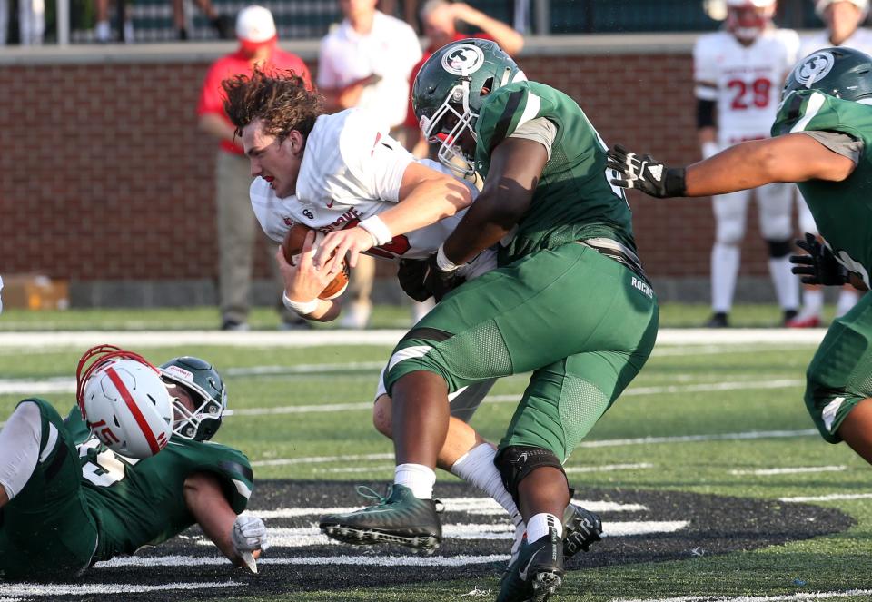 Center Grove’s Tyler Cherry gets sacked by Trinity’s Mitchell Toney. Sept. 2, 2022