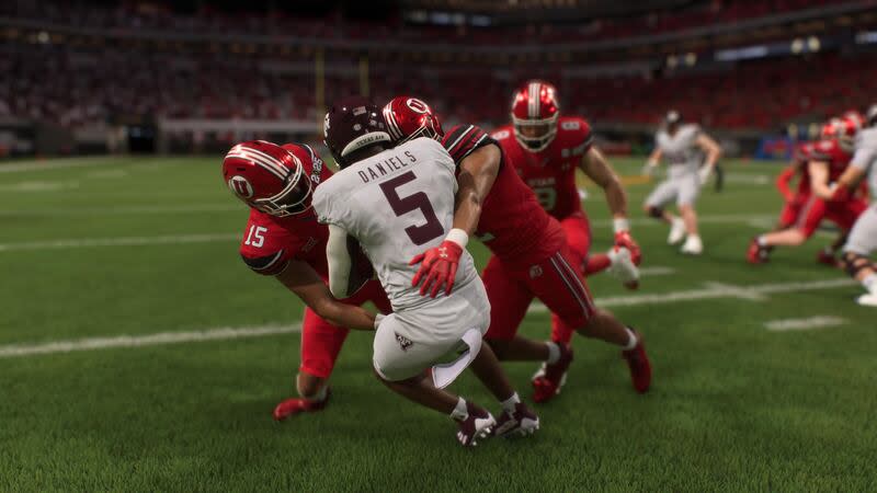 Utah safety Tao Johnson (15) and linebacker Sione Fotu, right, tackle Texas A&M running back Amari Daniels in the new EA Sports College Football 25 video game. | EA Sports College Football 25