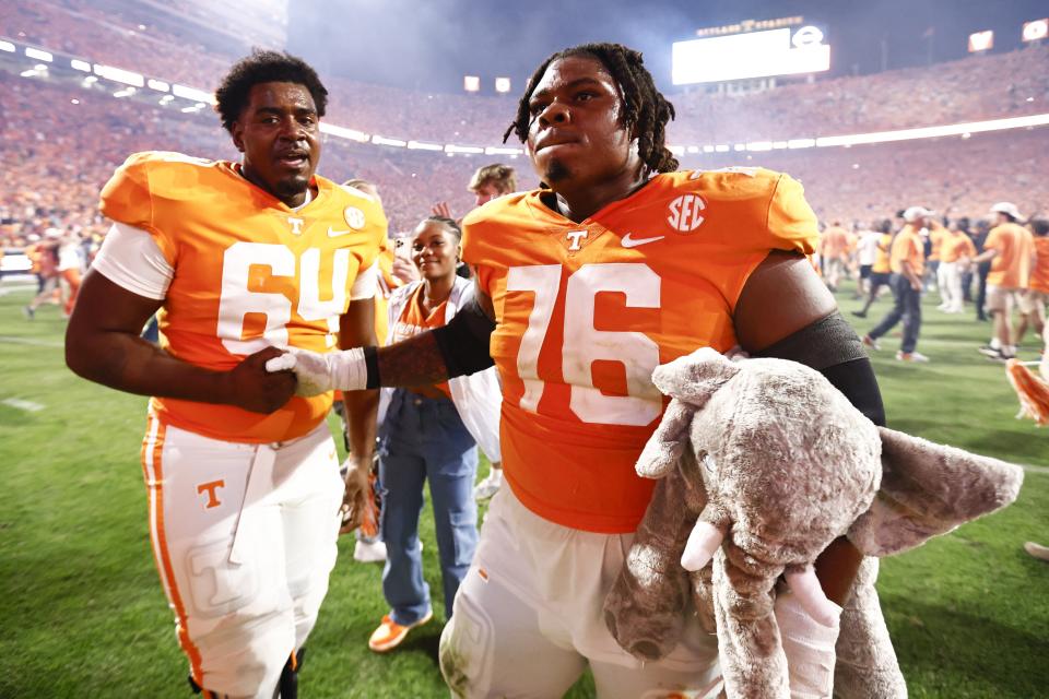 Tennessee offensive lineman Javontez Spraggins (76) holds a stuffed elephant as he celebrates with offensive lineman William Parker (64) after an NCAA college football game against Alabama, Saturday, Oct. 15, 2022, in Knoxville, Tenn. Tennessee won 52-49. (AP Photo/Wade Payne)